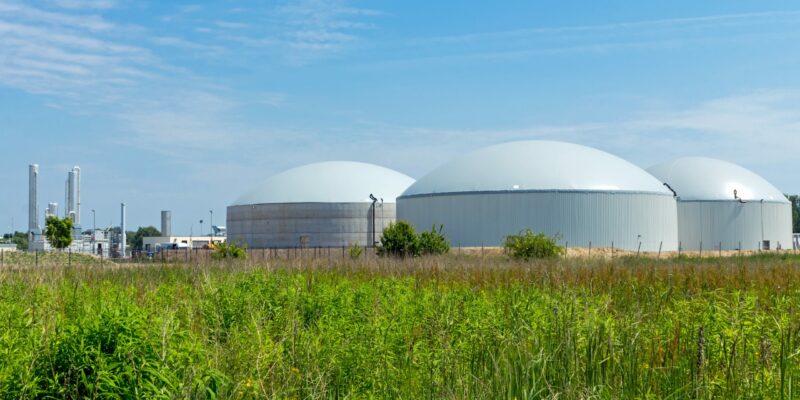 Green energy farm with dome shape buildings and a landscape.