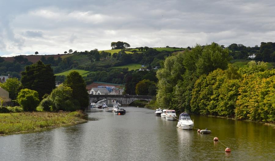 River Dart, Totnes, featuring boats on the water and a landscape.