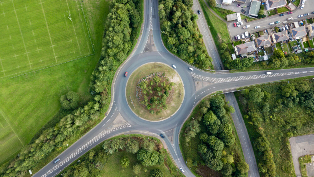 Top down aerial view of a traffic roundabout on a main road UK