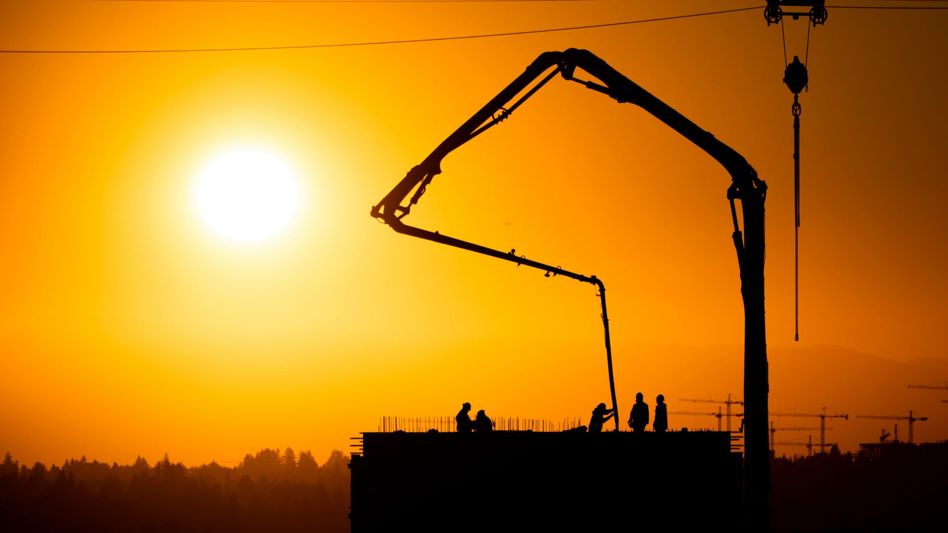 Construction workers at sunset