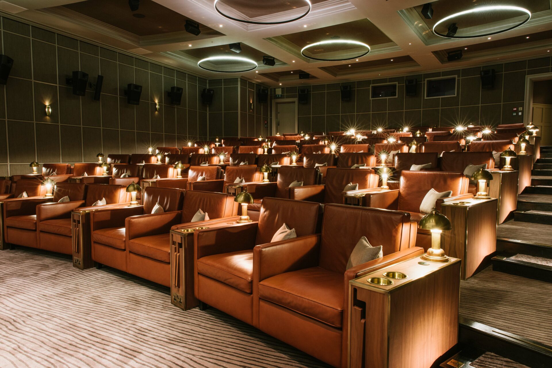 Luxury cinema room dimly lit with uplighting